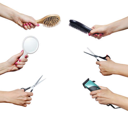 Hairdressers tools in hands isolated on whiteの写真素材