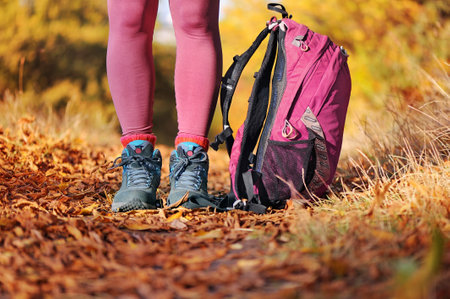 Close-up picture of hiker legs in boots and backpackの写真素材