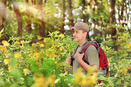 Side view portrait of a handsome traveler in the spring forestの写真素材