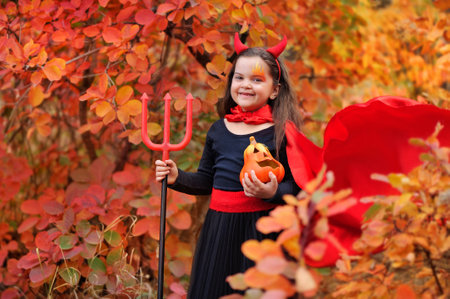 Closeup portrait of a girl wearing Halloween devil costumeの写真素材