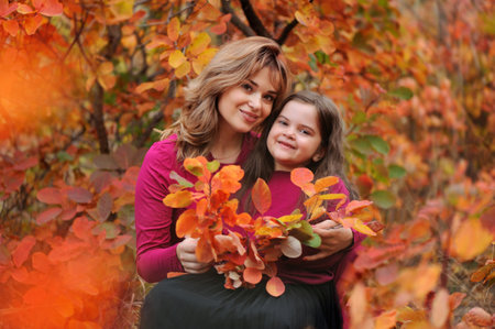 Happy family with autumn bouquet in the parkの写真素材