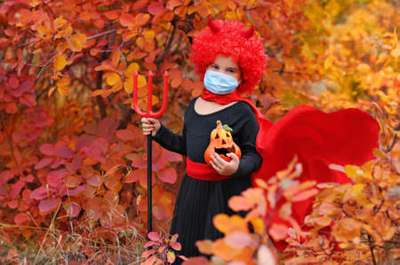 Girl going to the Halloween party wearing protective mask