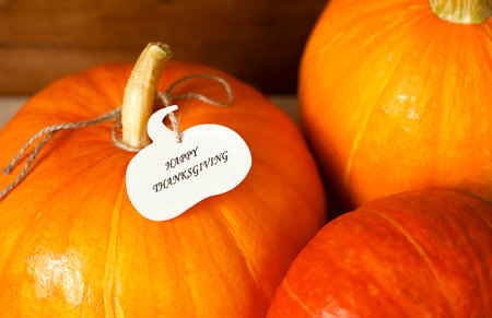 close-up of pumpkins with a note in the form of a pumpkin and textの写真素材