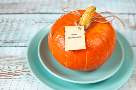 pumpkin with a tag on a blue plateの写真素材