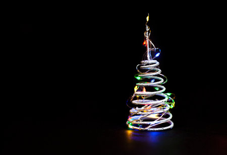 spiral in the form of a Christmas tree with a garland on a black background