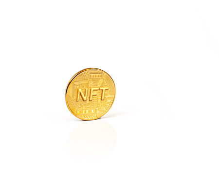 gold coin with the inscription NFT close-up on a white backgroundの写真素材