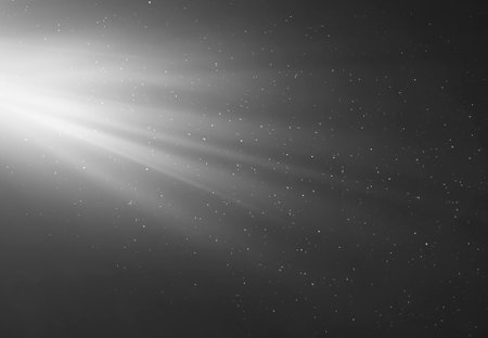 rays of light on a black background with flying particlesの写真素材