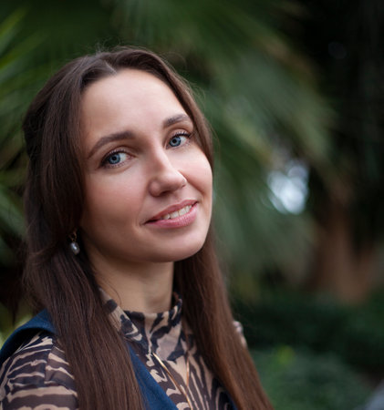 Portrait of a beautiful young woman with long brown hair and blue eyesの写真素材