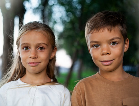 Portrait of two children looking at the camera in the park.の写真素材