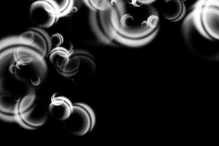 Abstract black and white bokeh on a black background.の写真素材