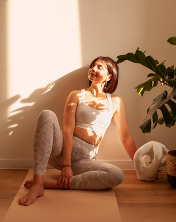 Beautiful young woman relaxing after doing yoga at home