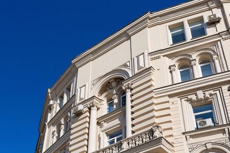 the facade of the building in the classical style against the blue skyの写真素材