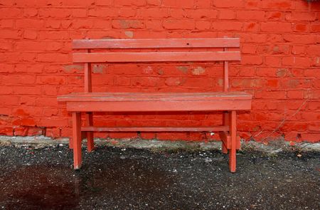Red wall and benchの写真素材