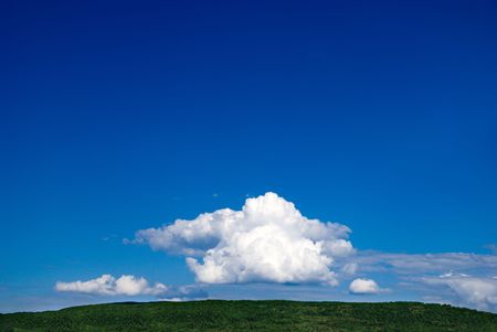 white clouds and green grassの写真素材