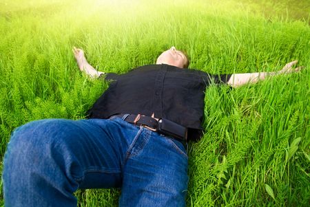 young man relax under spring sunの写真素材