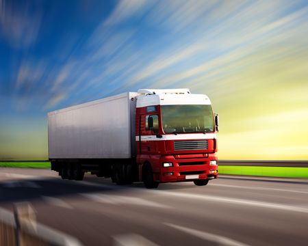 truck on highway and sunsetの写真素材