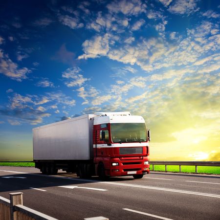 truck on highway and sunsetの写真素材