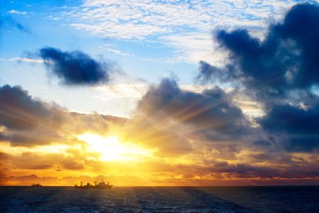 sunset in ocean and factory vesselの写真素材