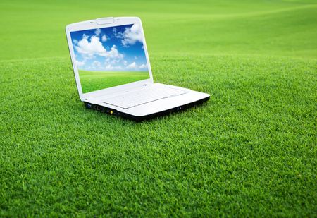 notebook on the green field of spring grassの写真素材