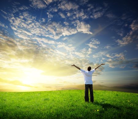 field of grass and happy young manの写真素材