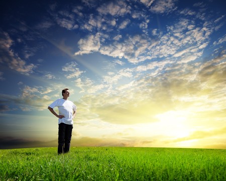 Young man on spring fieldの写真素材