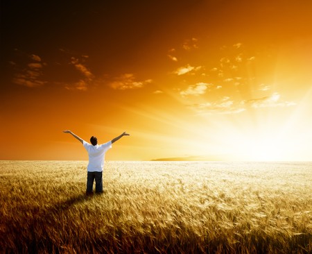 happy young man rest on wheat fieldの写真素材