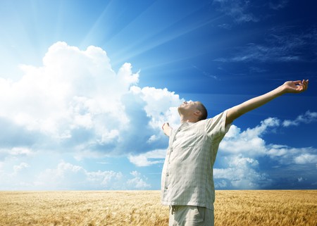 young man rest on wheat fieldの写真素材