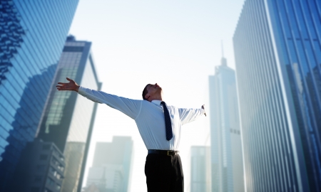 happy young businessman and big cityの写真素材