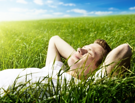young man in spring grassの写真素材