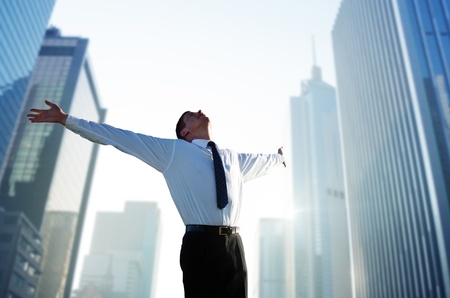 happy young businessman and big cityの写真素材