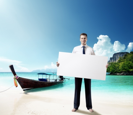 man on the beach of Thailand with empty board in handの写真素材