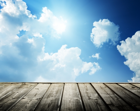 Cloudy blue sky and wood floorの写真素材
