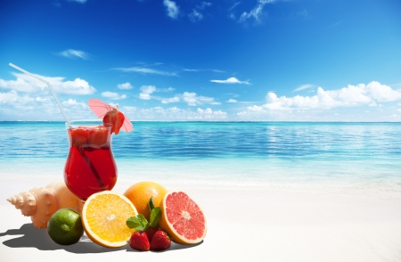 strawberry cocktail and tropical fruit on the beachの写真素材