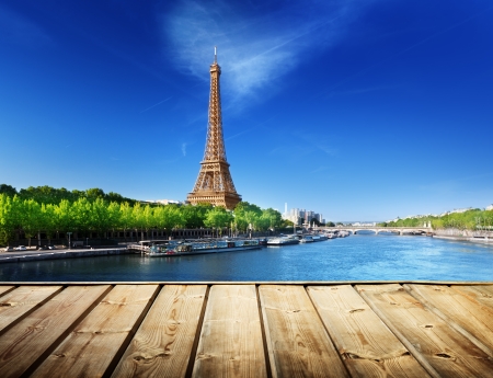 background with wooden deck table and Eiffel tower in Paris の写真素材