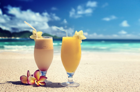 fresh fruit juices on a tropical beachの写真素材