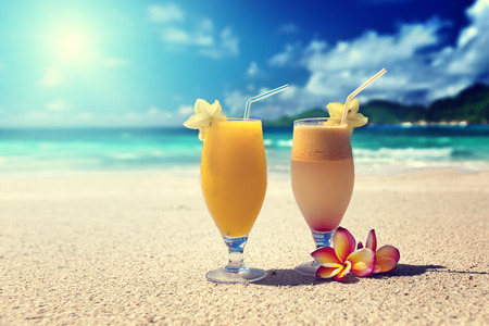 fresh fruit juices on a tropical beachの写真素材