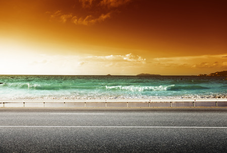 road and sea in sunset timeの写真素材