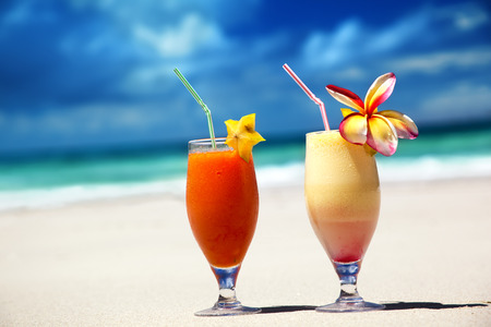 fresh fruit juices on a tropical beachの写真素材
