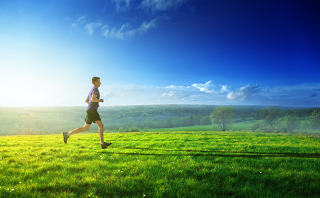 sunset and running young man の写真素材