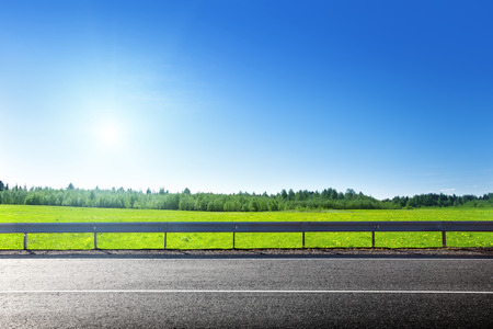 road and field of spring grassの写真素材