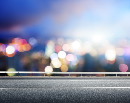 Asphalt road and blurred modern cityの写真素材