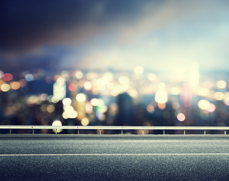 Asphalt road and blurred modern cityの写真素材
