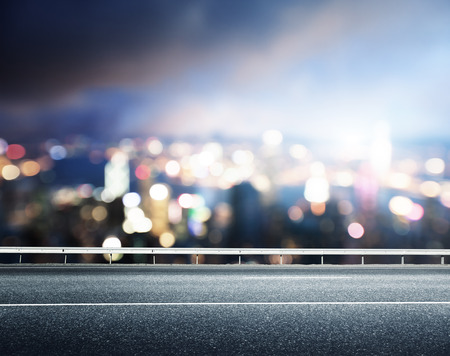Asphalt road and blurred modern cityの写真素材