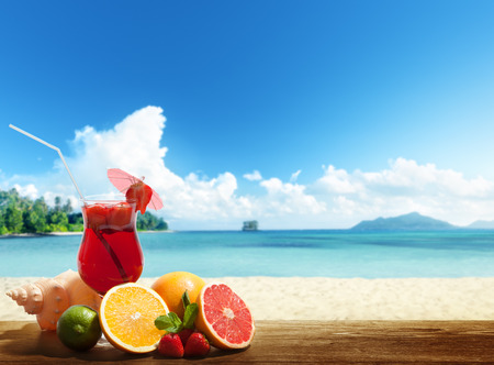 strawberry cocktail and tropical fruit on the beachの写真素材