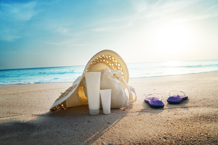 Sun lotion, hat  with bag at the tropical beachの写真素材