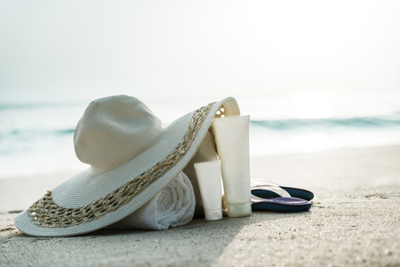 Sun lotion, hat  with bag at the tropical beachの写真素材