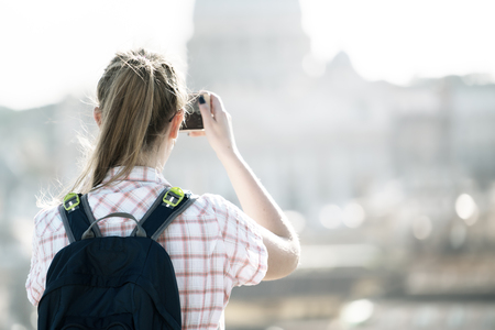Young woman takes a picture of Saint Peter  Cathedral , Rome, Italyの写真素材