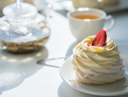 homemade cream cake on table in sunny room, tea partyの写真素材