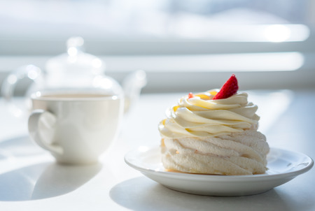 homemade cream cake on table in sunny room, tea partyの写真素材