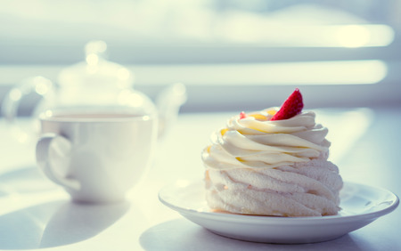 homemade cream cake on table in sunny room, tea partyの写真素材